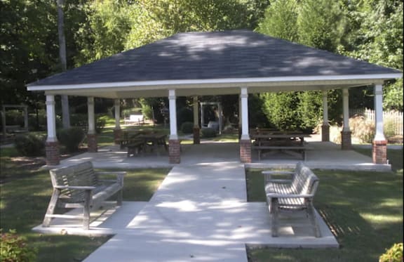A living room with a couch, coffee table, and a painting on the wall.