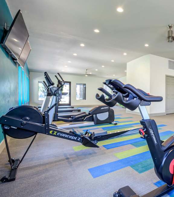 Dining Room With Kitchen View at Legacy Brooks, San Antonio, 78223 A gym with treadmills and elliptical machines.