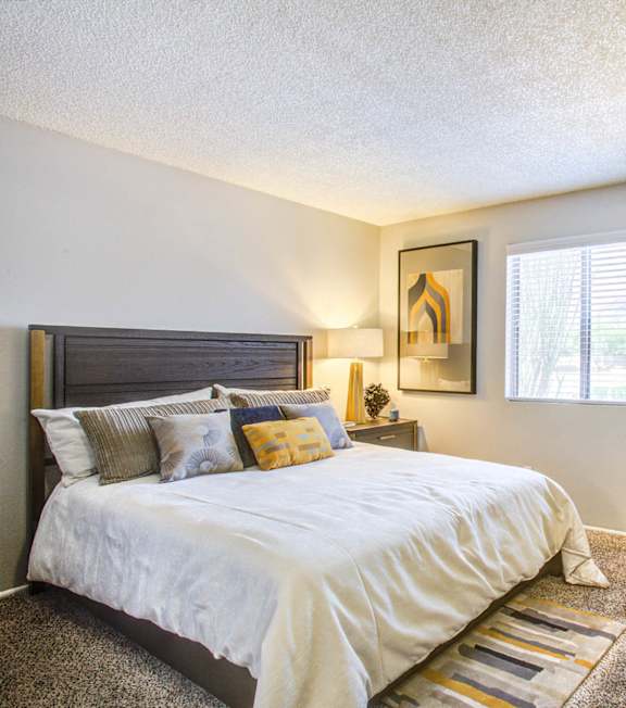 a bedroom with a bed and a ceiling fan
