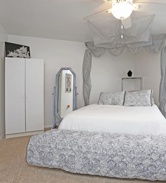 a bedroom with a large bed and a window at Spring Creek Townhomes, Illinois