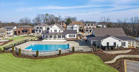 A large house with a pool in the backyard. at The Lofts at Town Madison, Madison, AL
