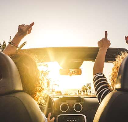 Couple driving in a convertible car at Alhambra Cove, Miami, Florida
