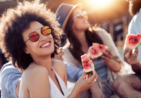 Group of friends outside eating watermelon at Alhambra Cove, Miami, 33167