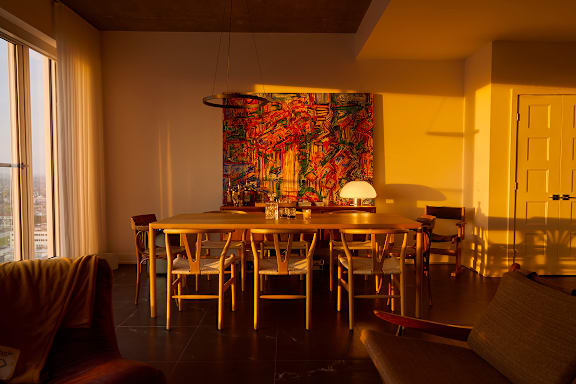 A living room with a green armchair and a white couch. at Le Columbia Apartments , Gatineau, J8Y 0A8