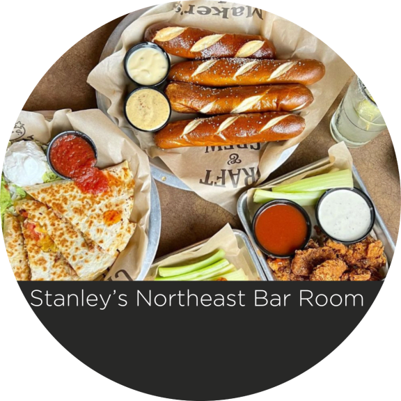 a box of food with sausages and bread and dipping sauces