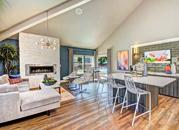 A modern living room with a fireplace and a dining area.