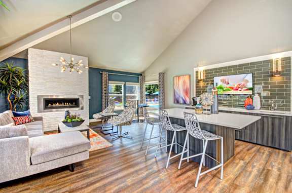 A modern living room with a fireplace and a dining area.