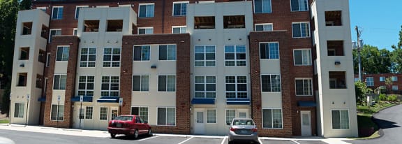 an apartment building with cars parked in front of it