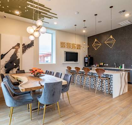 A modern dining room with a wooden table and chairs.