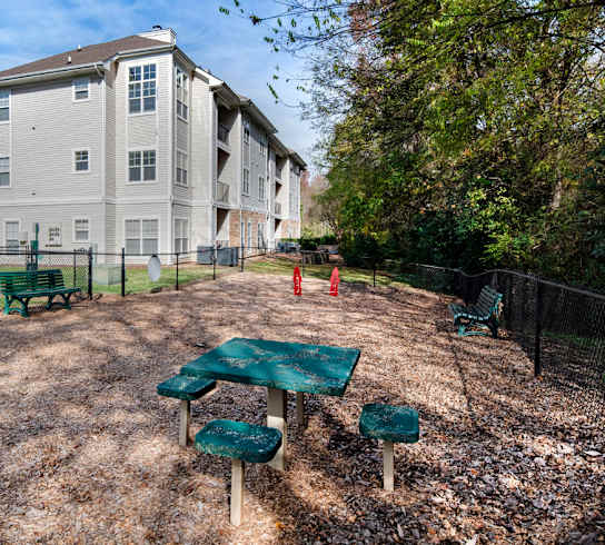 A large apartment complex with a playground in front.