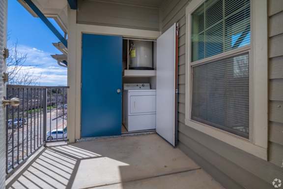 A blue door opens to a small kitchen area.