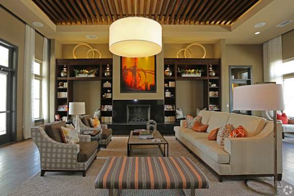 A living room with a fireplace and a large painting above it.