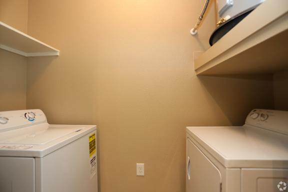 A small laundry room with a washer and dryer.