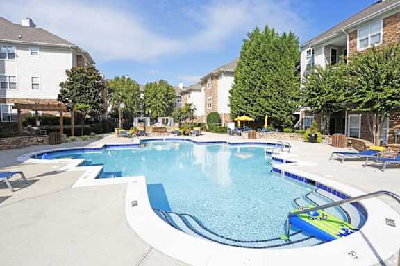 A large swimming pool surrounded by residential buildings.