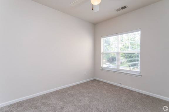 A room with a window and a ceiling light.