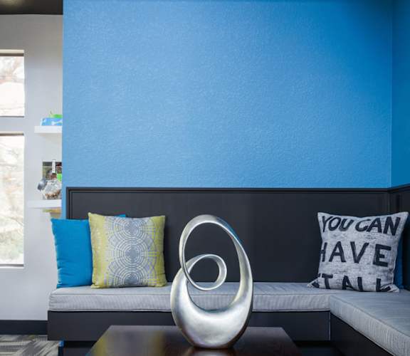 A blue wall with a white pillow and a sign that says "You can have stall".