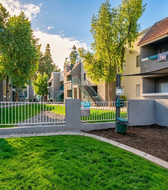 A sunny day in a residential area with apartments and a green lawn.