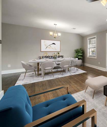 A living room with a white couch, a blue chair, and a coffee table at Balfour Marietta Apartments, Marietta, GA, 30060