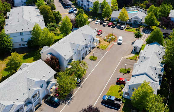 A bird's eye view of a residential area with houses and cars.