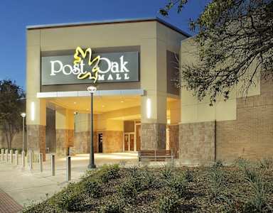 The Post Oak Mall is a large building with a lot of windows and lights.