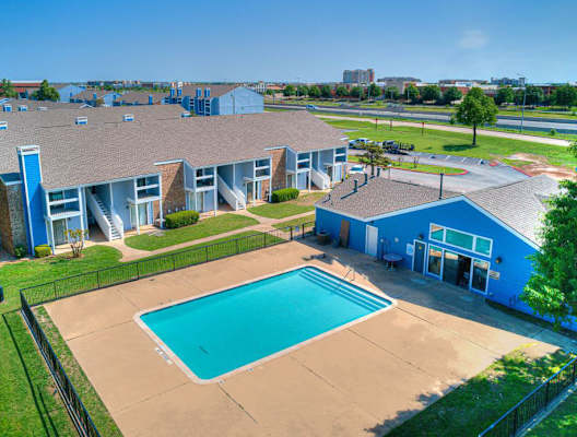 an aerial view of a building with a swimming pool