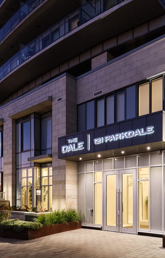 The exterior of a modern building named "The Dale" at night.