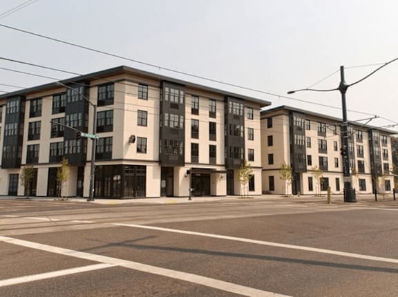 A large building with a lot of windows is in the background.