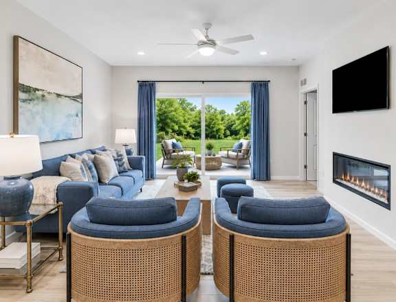 A living room with a fireplace and a television on the wall.