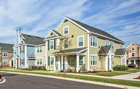 A row of houses with a blue sky in the background.