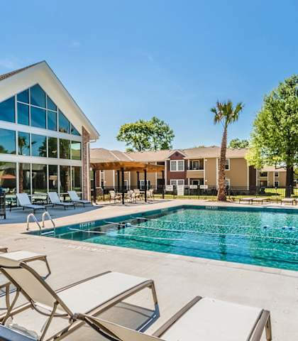 the preserve at ballantyne commons pool with chairs and a building with a pool at Lakecrest Village, Houston