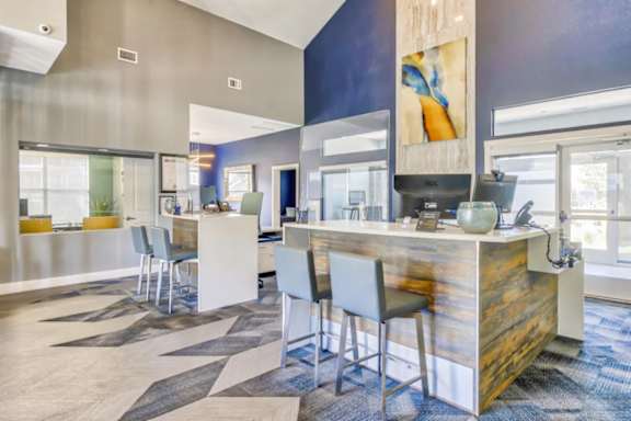 A modern office space with a reception desk and chairs.