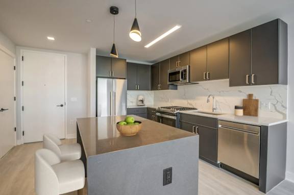 A modern kitchen with a dining table and chairs.