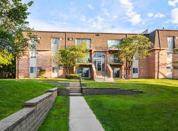 A brick building with a green lawn in front at Willow Hill Apartments, Justice, IL, 60458