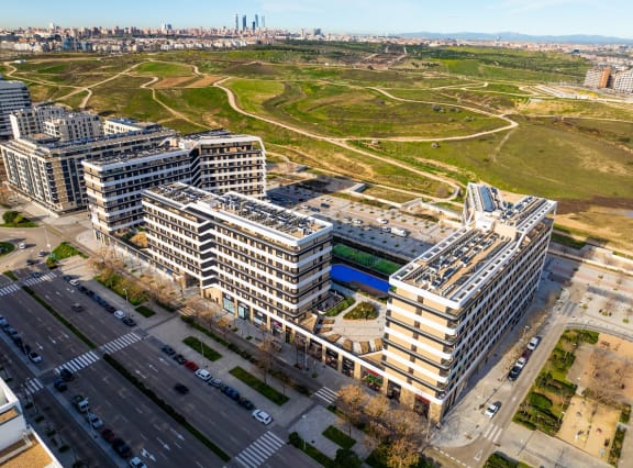 an aerial view of a city with buildings and an open field