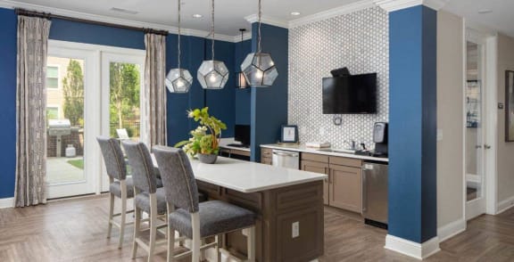 a kitchen and dining room with blue walls and a table and chairs