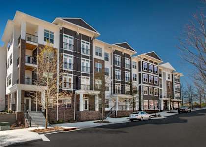 an exterior view of an apartment building on a snowy street