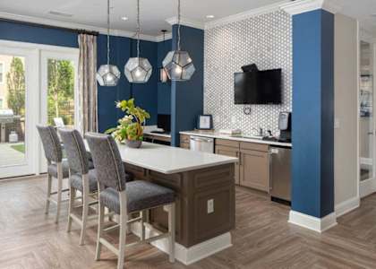 a kitchen and dining room with blue walls and a table and chairs