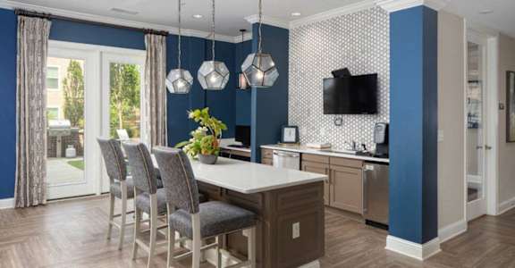 a kitchen and dining room with blue walls and a table and chairs