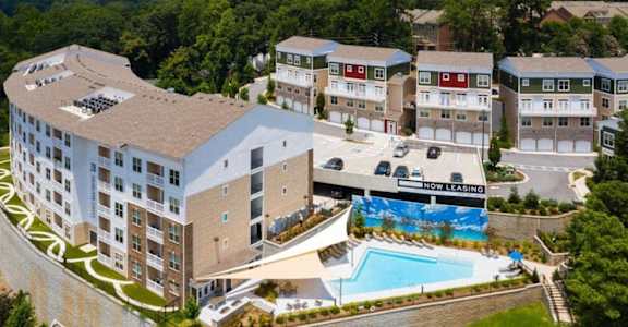 an aerial view of a hotel and apartments with a swimming pool
