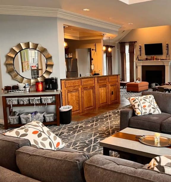 A living room with a grey couch and a wooden cabinet.