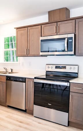 A kitchen with wooden cabinets and stainless steel appliances.