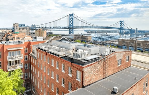 A view of a cityscape with a bridge in the background.
