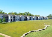 Thumbnail 8 of 22 - Exterior of apartment buildings and grassy field
