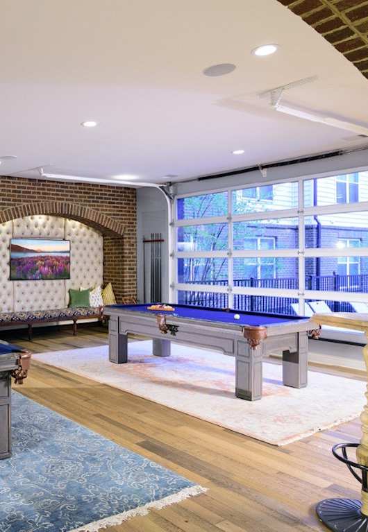 a lounge area with couches and a coffee table in front of a pool