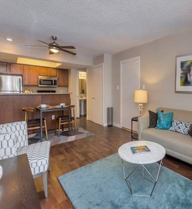A living room with a couch, chair, and a table.