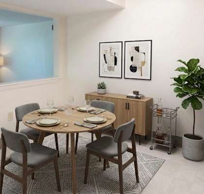A dining room with a round table set for six.