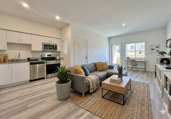 A modern living room with a grey sofa and a wooden coffee table.