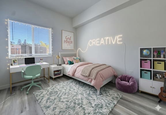 A bedroom with a bed, desk, chair, and a neon sign that says "Creative".