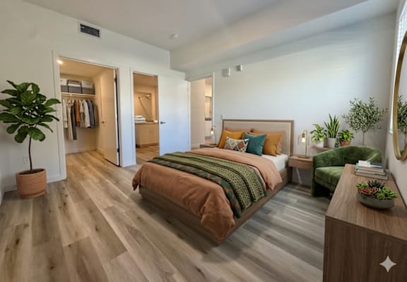 A bedroom with a bed, a plant, and a mirror.