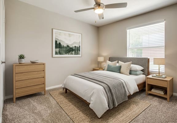 A bedroom with a bed, nightstand, and a painting on the wall.